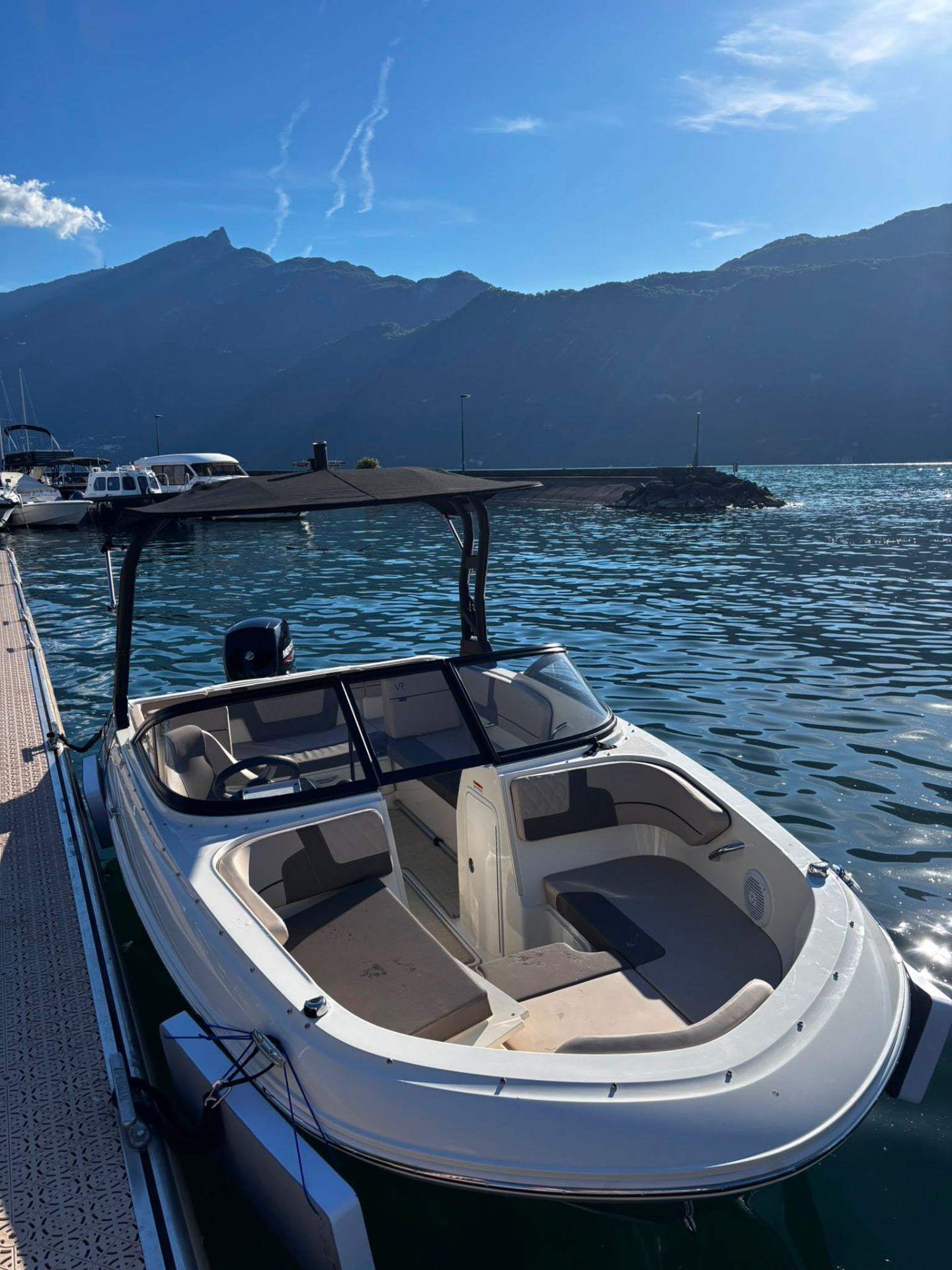 Gros plan sur le poste de pilotage du Bayliner VR4 : volant, tableau de bord et sièges beige